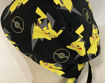 May include: Black scrub hat with a yellow Pikachu and Pokeball pattern.