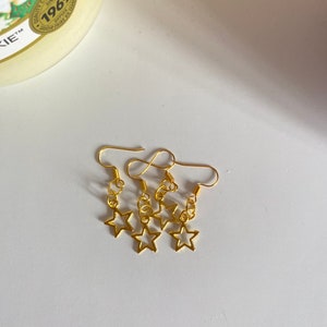 Gold star earrings | Gold | Golden stars | Stars | Star earrings | Dangle earrings | Star charms | Gold star | Golden | Star dangle |