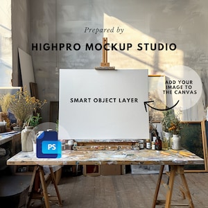 May include: A white canvas on an easel in an artist's studio. The canvas is a smart object layer, meaning you can add your own image to it. The text "Prepared by HIGHPRO MOCKUP STUDIO" is at the top of the image. The text "SMART OBJECT LAYER" is below the canvas. The text "ADD YOUR IMAGE TO THE CANVAS" is on the right side of the image.