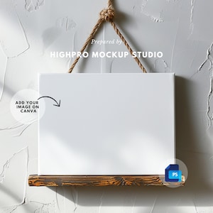 May include: A white canvas mockup hanging on a rope with a wooden shelf underneath. The canvas is blank and ready for your design.  Prepared by HIGHPRO MOCKUP STUDIO.