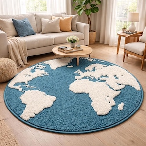 May include: A round, blue rug with a white world map design. The rug is placed on a hardwood floor in a living room setting, with a sofa, pillows, and a coffee table visible in the background.