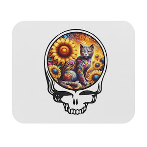 May include: A black and white illustration of a skull with a colorful cat inside. The cat is surrounded by sunflowers and other floral designs. The skull is a popular symbol of the Grateful Dead.