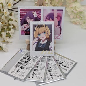 May include: Five silver card sleeves with a white background and black text. The text on the sleeves reads "[推しの]子".