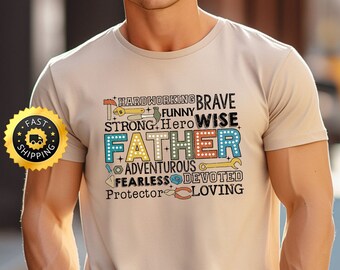 May include: A beige t-shirt with a graphic design featuring the word "Father" in large, colourful letters surrounded by smaller words describing a father's qualities, such as "hardworking", "brave", "strong", "wise", "funny", "adventurous", "fearless", "devoted", "protector", and "loving".