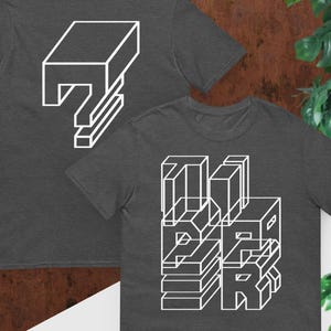 May include: Two dark gray t-shirts with white geometric designs. One shirt displays a stacked, 3D-style wordmark, while the other shows a similar design on the back. The shirts are short-sleeved and made of a soft material.