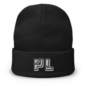 May include: A black beanie with a folded brim. The beanie features the white letters "PL" embroidered on the front. The hat is made of a soft, knitted material.