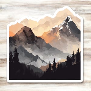 May include: A sticker featuring a mountain landscape design. The artwork depicts a range of mountains in shades of gray, black, and white, with a warm orange and yellow sky. Silhouetted trees are in the foreground.