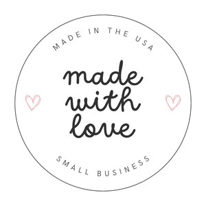 May include: A circular white sticker featuring the black text MADE IN THE USA at the top, the phrase made with love in the center, and SMALL BUSINESS at the bottom. Two small pink hand-drawn hearts are positioned on the left and right sides.