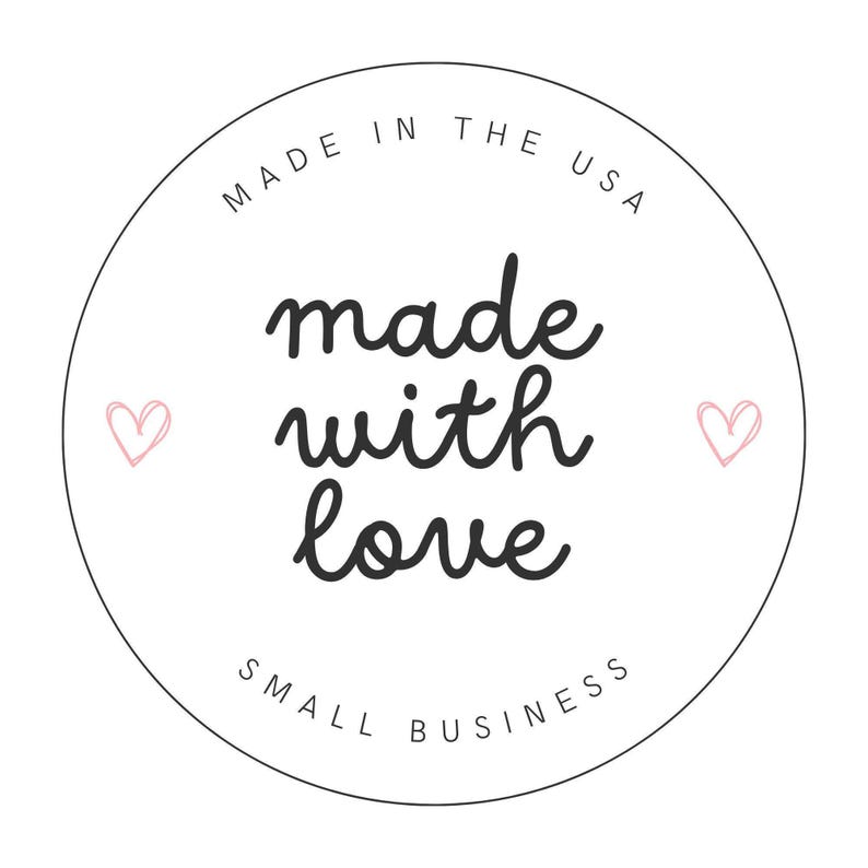 May include: A circular white sticker featuring the black text MADE IN THE USA at the top, the phrase made with love in the center, and SMALL BUSINESS at the bottom. Two small pink hand-drawn hearts are positioned on the left and right sides.