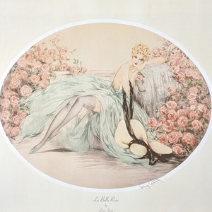 Vintage French art print 'La Belle Rose' by Louis Icart is an illustration of a woman reclined elegantly amongst a bower of pink roses, wearing a flowing, light turquoise dress