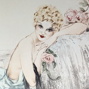 Close-up of 'La Belle Rose' by Icart focusing on the woman's face and upper body. She has a curly blonde bob, red lips, and an inviting expression.