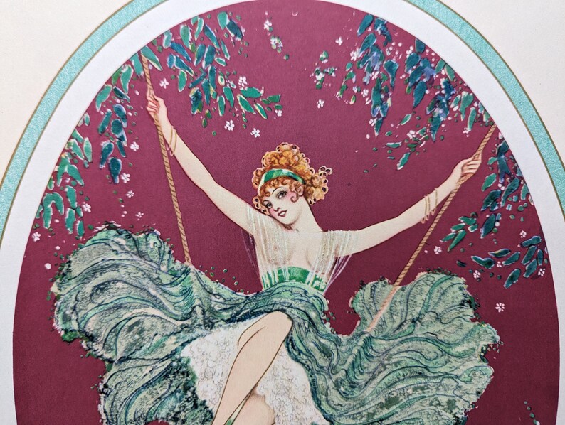May include: Art Deco illustration of a woman on a swing. She wears a green dress and a matching headband. The background is a deep red with green foliage and white flowers. The image is framed with a white border and a teal accent.