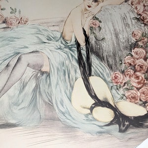 May include: An art deco style print featuring a woman in a flowing blue dress, resting on a chaise lounge. A large sun hat with a black ribbon lies nearby. Pink roses frame the scene, with the artist's signature in the lower right corner.