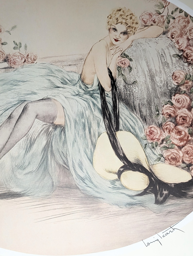 May include: An art deco style print featuring a woman in a flowing blue dress, resting on a chaise lounge. A large sun hat with a black ribbon lies nearby. Pink roses frame the scene, with the artist's signature in the lower right corner.