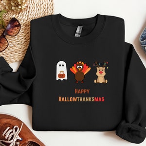 Happy Hallowthanksmas sweatshirt with ghost, turkey, and reindeer for Halloween, Thanksgiving, and Christmas