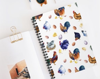 May include: A white spiral bound notebook with a colorful watercolor pattern of chickens, chicks, and eggs. The pattern is repeated throughout the notebook.