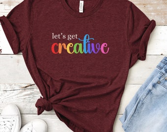 Camiseta "Let's Get Creative" - Camiseta inspiradora para profesores y artistas con diseños coloridos.