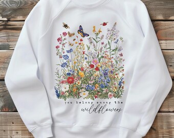 May include: White sweatshirt with a floral print and the text "you belong among the wildflowers".