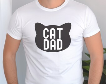 May include: White t-shirt with a black cat head graphic and the text "CAT DAD" in white letters.