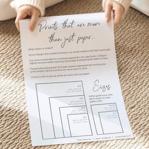 May include: A white sheet of paper with text that reads "Prints that are more than just paper..." and describes the different sizes of prints available. The sizes are listed in millimeters and inches. The text also says "A little guide to our sizes. Mix & match to create gallery walls."