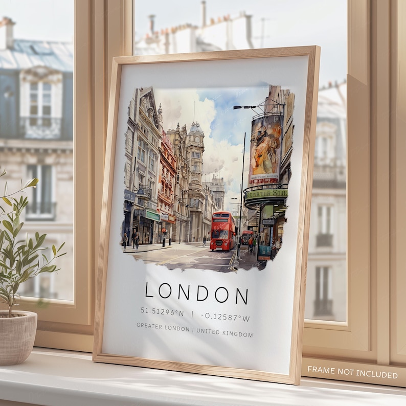May include: A watercolor painting of a street scene in London, England. The painting features red double-decker buses, brick buildings, and a sign that reads "The Victoria", with the coordinates 51.51296&deg;N - 0.12587&deg;W and the text "GREATER LONDON | UNITED KINGDOM".