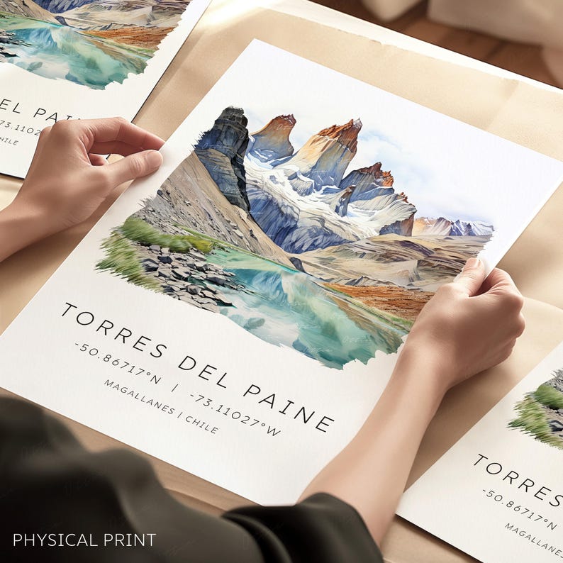May include: A watercolor painting of the Torres del Paine National Park in Chile. The painting depicts the iconic granite peaks of the park, with a turquoise lake in the foreground. The text "Torres del Paine" is written in black at the bottom of the painting, along with the coordinates of the park: -50.86717&deg;N | -73.11027&deg;W. The text "Magallanes | Chile" is also written below the coordinates.