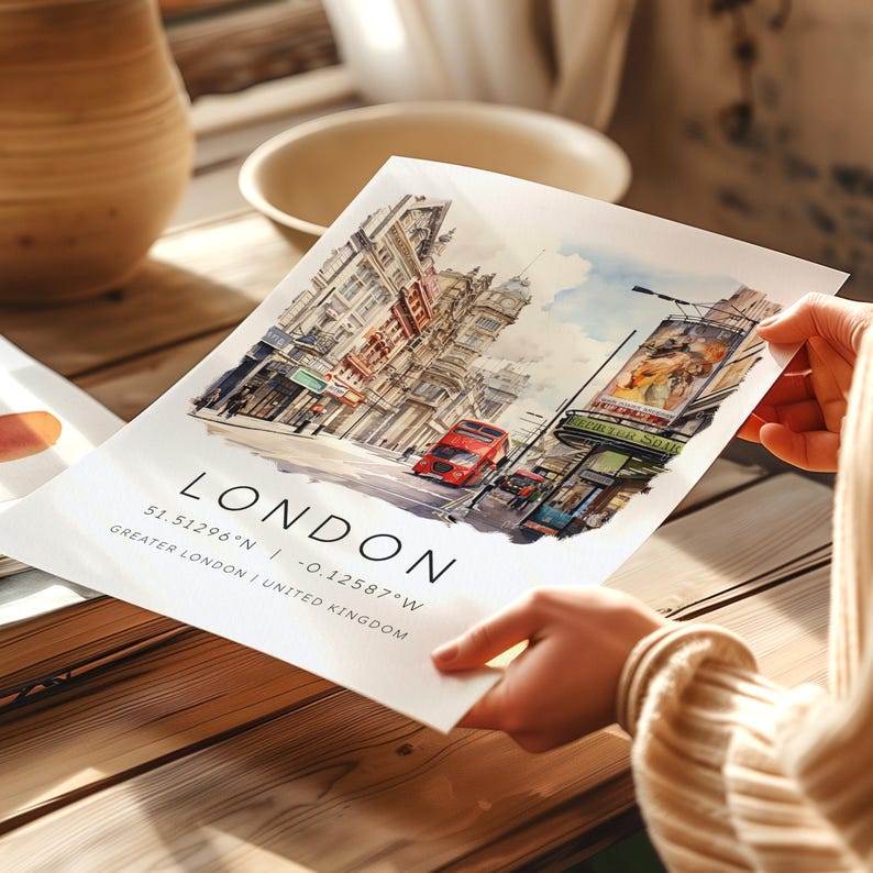 May include: A watercolor painting of a London street scene with a red double-decker bus, buildings, and a sign for "The Savoy" theater. The text "LONDON 51.5129&deg;N -0.12587&deg;W GREATER LONDON | UNITED KINGDOM" is printed below the image.