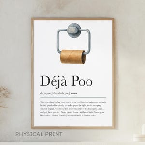 May include: Framed print with the text "Déjà Poo" and a definition. The image features a watercolor illustration of a toilet paper holder with an empty roll. The words "PHYSICAL PRINT" are at the bottom.