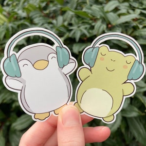 Cute penguin and frog stickers with headphones.  Frog and penguin illustration. Actually autistic, ADHD, neurodivergent, HSP, music lover.