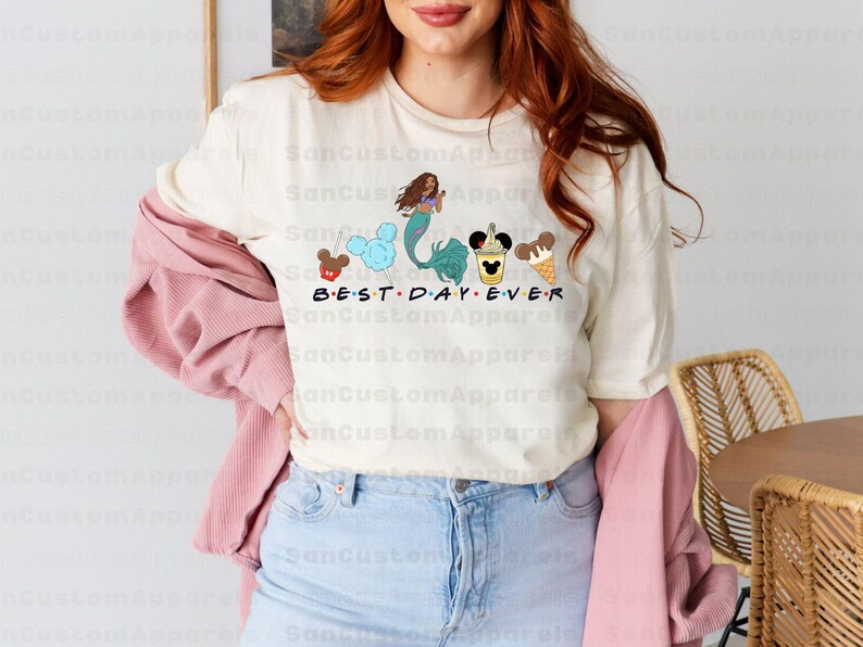 a woman with red hair wearing a mickey mouse shirt