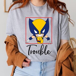 a woman wearing a t - shirt that says trouble