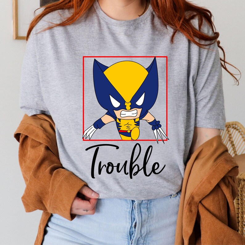 a woman wearing a t - shirt that says trouble