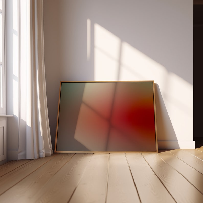 K&ouml;nnte beinhalten: Ein gerahmter abstrakter Kunstdruck mit einem Farbverlauf von Gr&uuml;n nach Rot. Der Druck h&auml;ngt an einer wei&szlig;en Wand in einem Raum mit Holzboden.