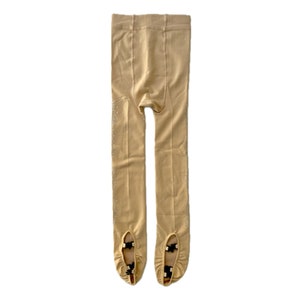 May include: Beige tights with a subtle sparkle and black straps at the toes.