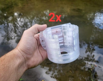 Könnte beinhalten: Ein durchsichtiges, 3D-gedrucktes Objekt aus Kunststoff mit zylindrischer Form und einem Loch in der Mitte. Das Objekt wird in einer Hand gehalten. Der Text "2x" ist auf dem Bild sichtbar.