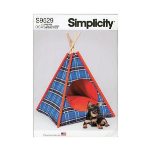 May include: Simplicity sewing pattern S9529 for a pet teepee. The pattern is for one size and includes instructions for making a blue and red plaid teepee with a red entrance.