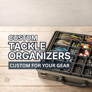 May include: A dark olive green plastic tackle box featuring multiple internal compartments filled with various fishing lures, hooks, weights, and pliers. The text CUSTOM TACKLE ORGANIZERS CUSTOM FOR YOUR GEAR is overlaid on the left side of the image.