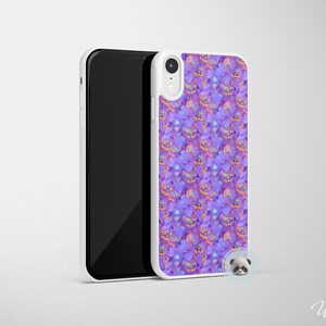 May include: A white phone case with a purple and orange pattern of jack-o'-lantern faces. The case is designed for a phone with a camera bump.