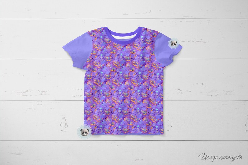 May include: A purple short-sleeved t-shirt with a repeating pattern of purple, orange, and yellow jack-o'-lanterns. The shirt has a plain purple collar and sleeves.