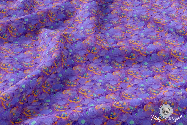 May include: Purple fabric with a repeating pattern of orange and yellow jack-o'-lantern faces and teal circles.