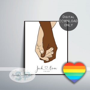 May include: A digital download print of two hands holding each other, one hand is brown and the other is white. The text below the hands reads "Jack & Tom 03.10.2021". A rainbow heart is in the bottom right corner.