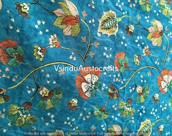 May include: Teal blue fabric with a floral pattern in shades of orange, green, and brown. The fabric has a velvety texture.