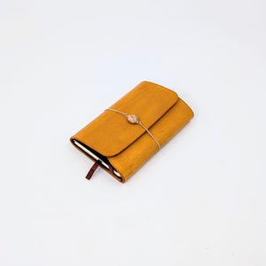 Tri-fold Leather notebook cover for a6 sized journals. Leather travelers notebook.
