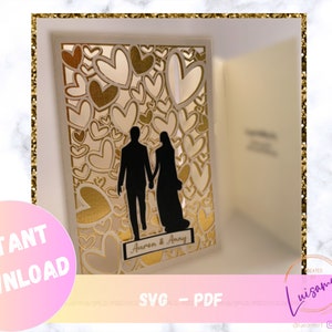 May include: A white card with a gold heart design and a silhouette of a couple walking. The card has the text "Aaron & Amy" on the bottom.