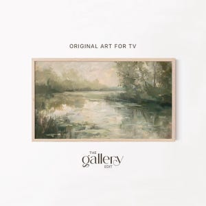 May include: A framed landscape painting with a serene lake scene. The artwork features soft, muted greens and beige tones, with reflections on the water. The text "ORIGINAL ART FOR TV" is at the top, and "THE gallery EDIT" is at the bottom.