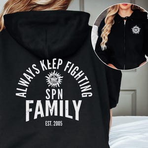May include: Black hooded sweatshirt with a white graphic print that says "Always Keep Fighting SPN Family Est. 2005".