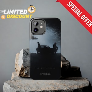 May include: Black phone case with a silhouette of two people standing in front of a car. The text "End of the Road" and "Supernatural" are printed on the case.