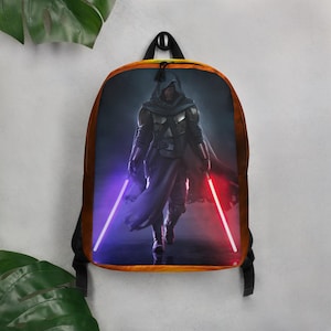 May include: A black backpack with a colorful image of a hooded figure wielding two lightsabers, one red and one blue. The background is a dark blue with a yellow and orange gradient.