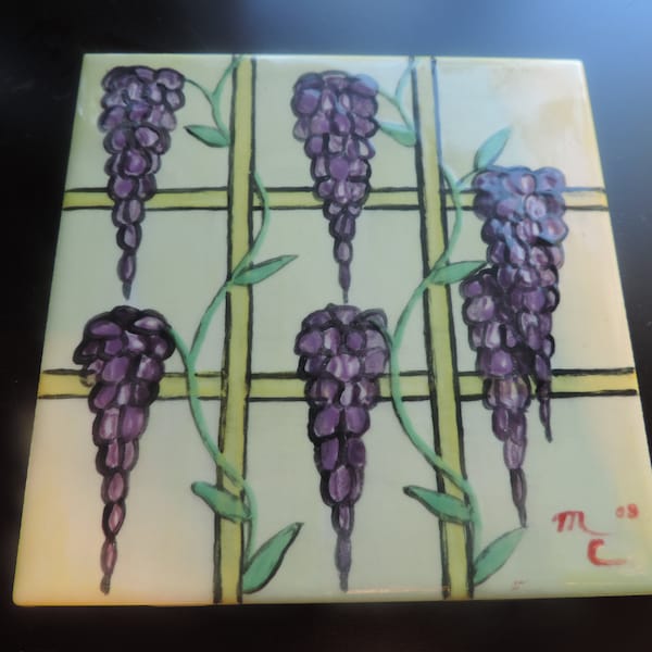 Hand glazed ceramic tile of wisteria on fence