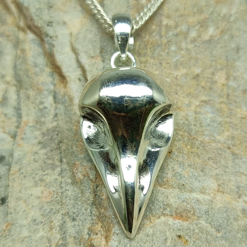 Puede incluir: Pendiente de plata con forma de cabeza de p&aacute;jaro con detalles elaborados.